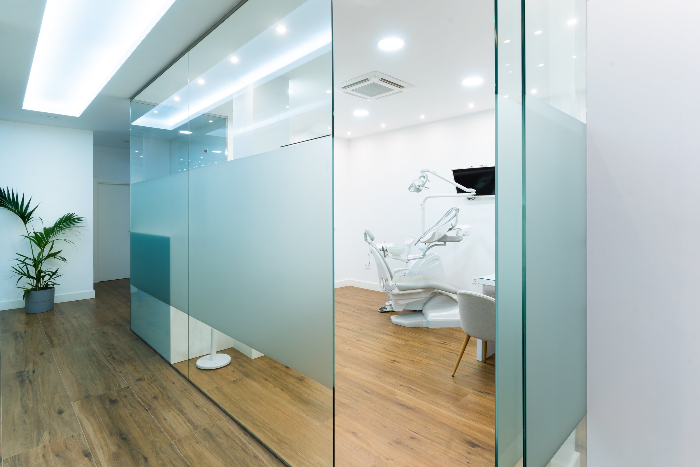 Moderne, helle Zahnarztpraxis Zahnschön mit Glaswänden und Behandlungszimmer